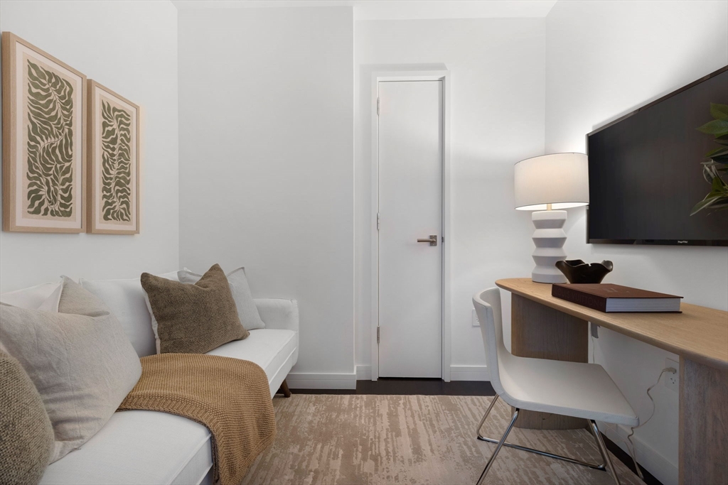 150 Seaport Boulevard, Unit B Boston, MA 02210 - Photo 11 of 27 a living room with furniture and a flat screen tv