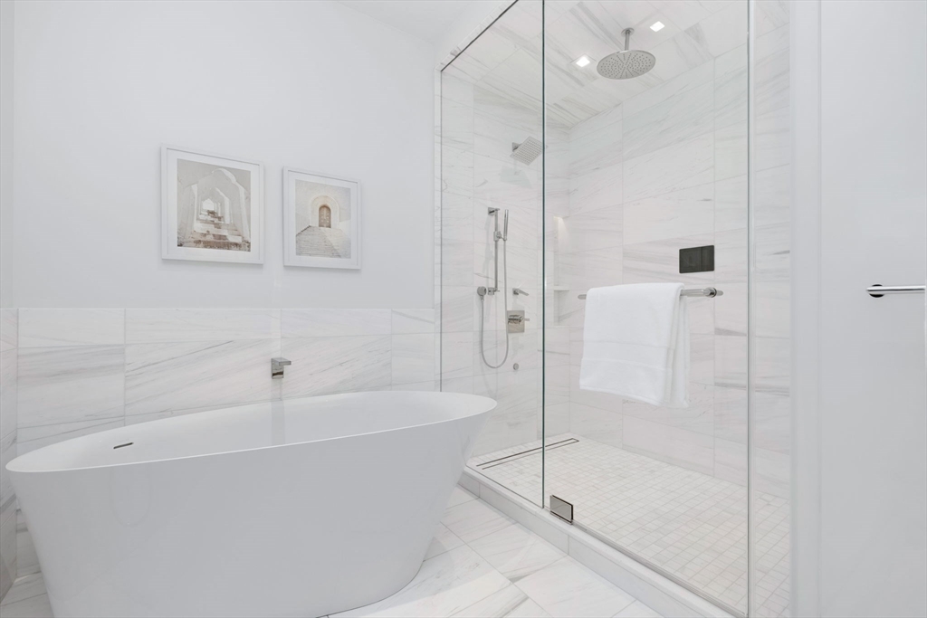 150 Seaport Boulevard, Unit B Boston, MA 02210 - Photo 13 of 27 a white bath tub sitting next to a shower