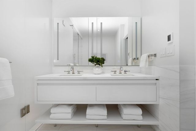 a bathroom with a sink mirror and vanity