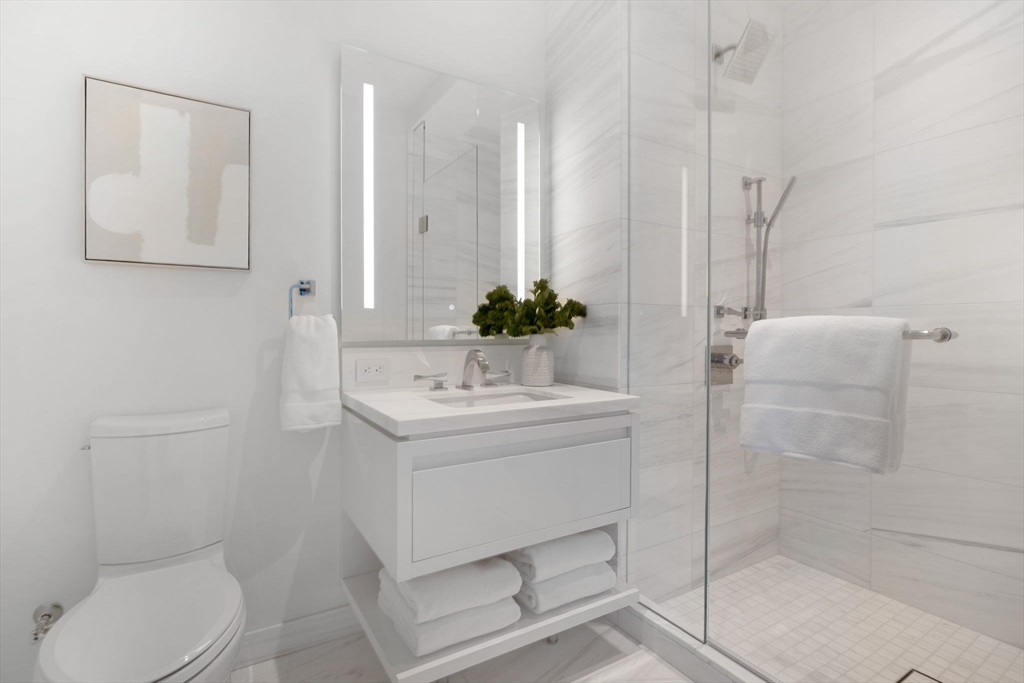150 Seaport Boulevard, Unit B Boston, MA 02210 - Photo 16 of 27 a bathroom with a sink a toilet and shower
