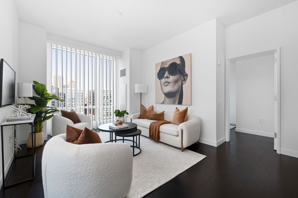 150 Seaport Boulevard, Unit B Boston, MA 02210 - Photo 3 of 27 a living room with furniture and wooden floor