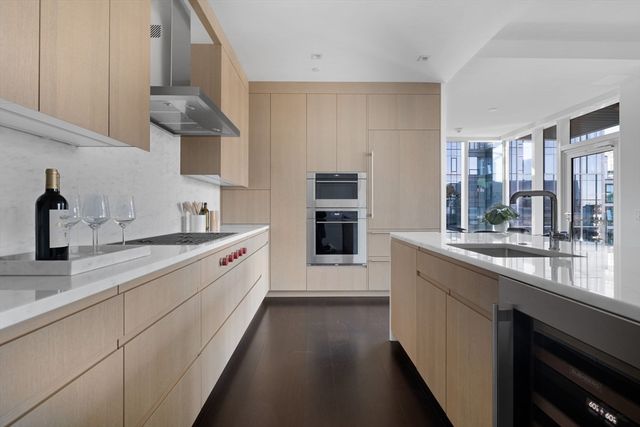 a large kitchen with a lot of counter space and a sink