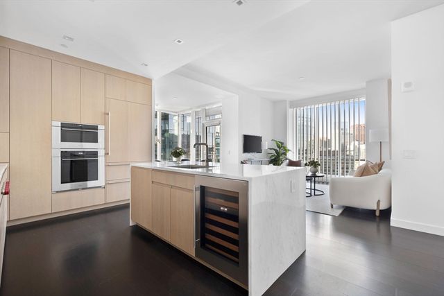 a kitchen with counter top space and living room