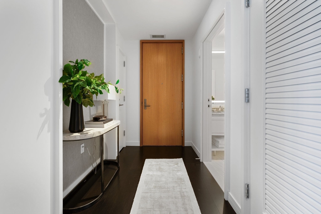 150 Seaport Boulevard, Unit B Boston, MA 02210 - Photo 9 of 27 a bathroom with a sink a mirror and a potted plant