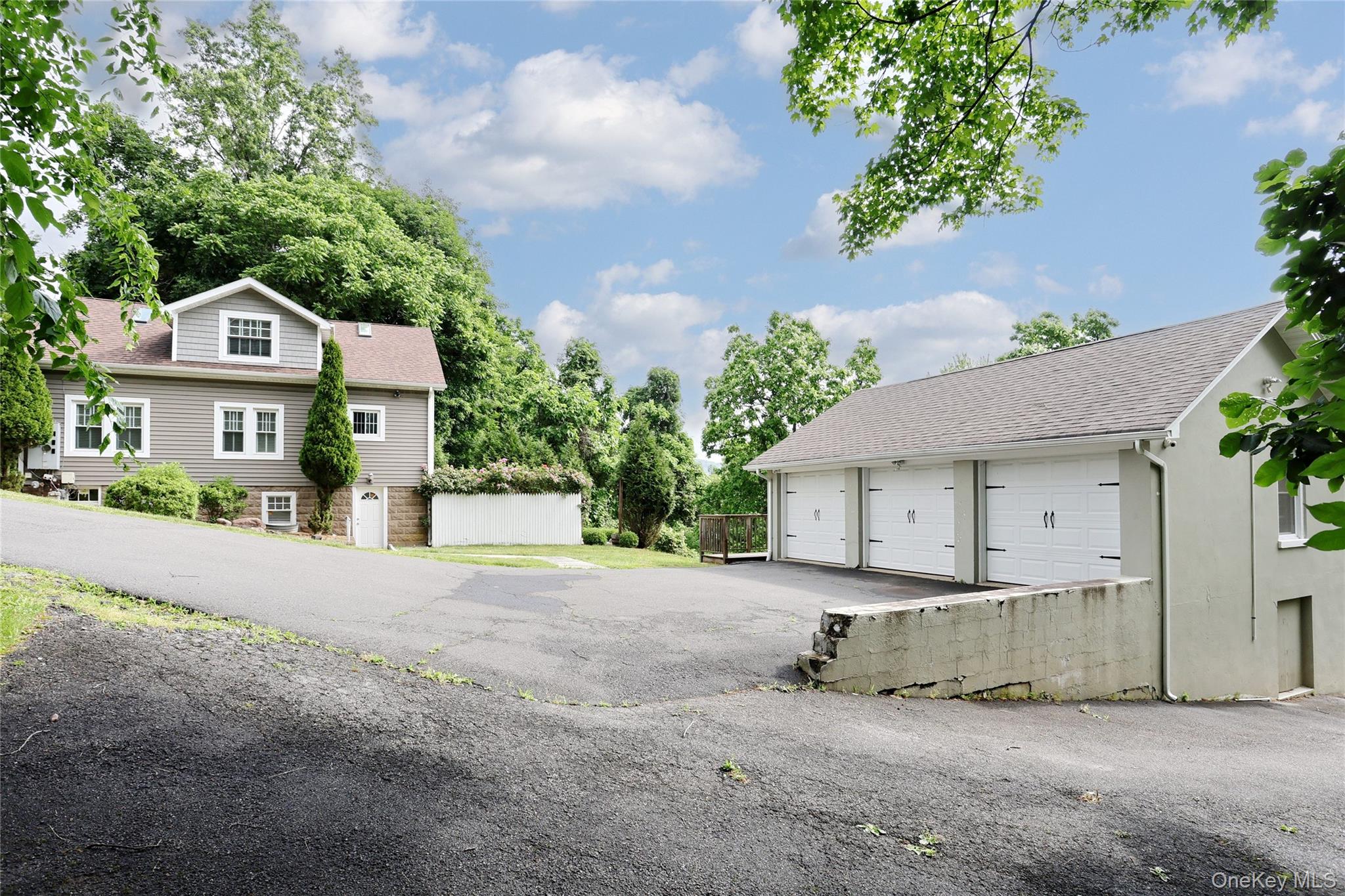 254 North Main Street New City, NY 10956 - Photo 31 of 37 a front view of a house with a garden and trees