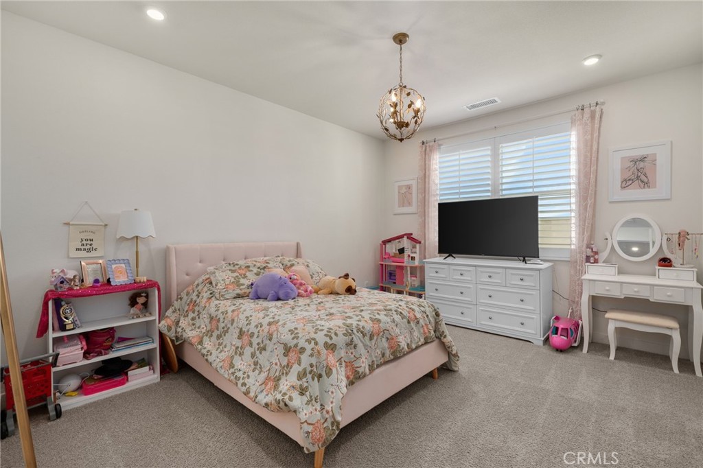 16155 New Canaan Court Riverside, CA 92504 - Photo 20 of 26 a bedroom with a bed and a flat screen tv
