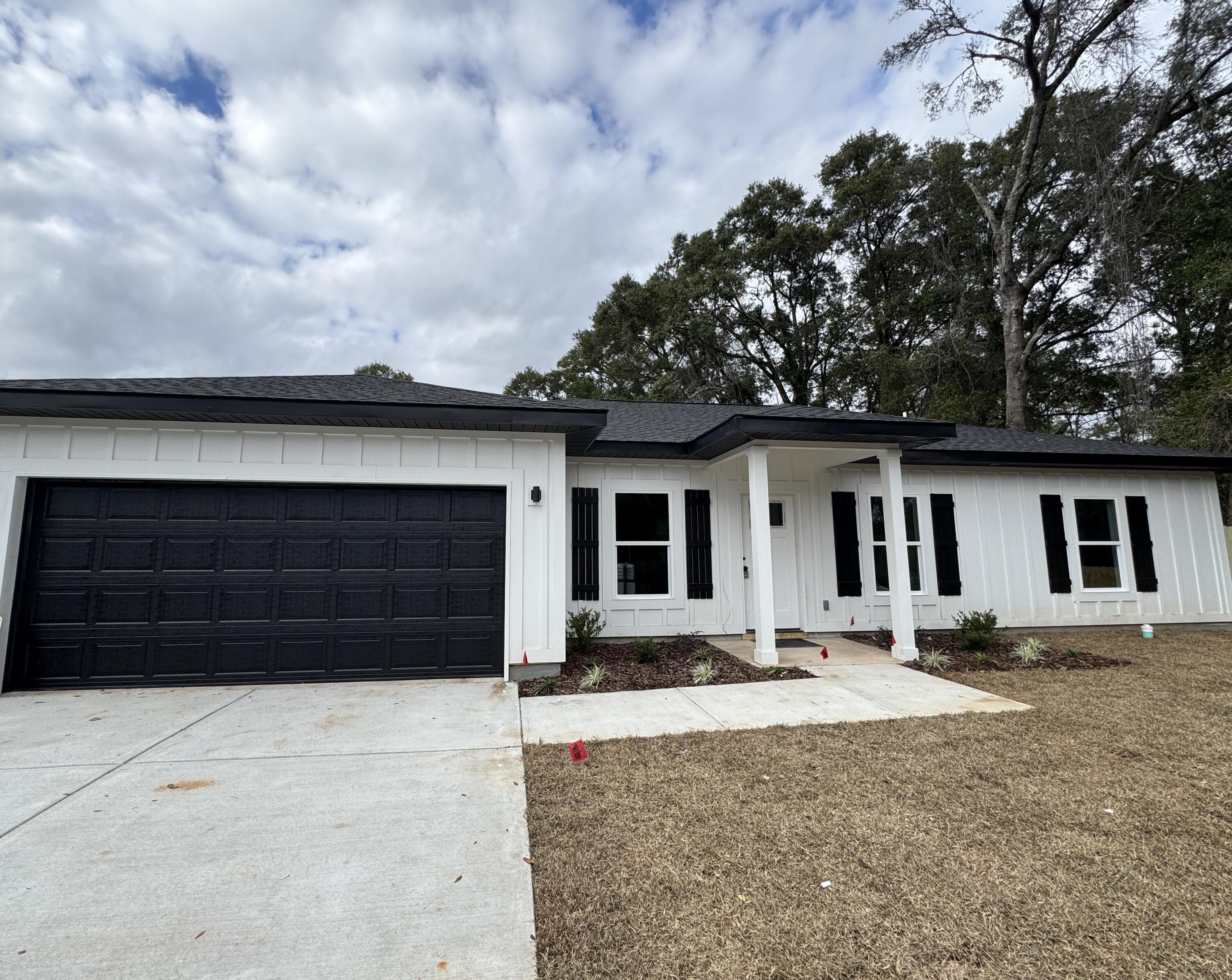 300 Reed Avenue Crestview, FL 32539 - Photo 1 of 1 a front view of a house with a yard and garage