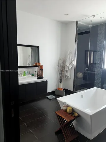 a bathroom with a double vanity sink and mirror