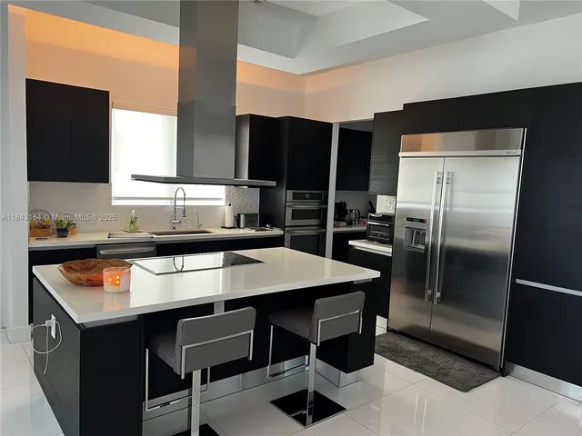 a kitchen with a refrigerator a sink and a stove