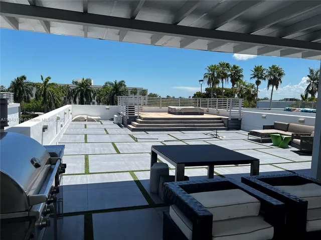 a living room with furniture a rug and a fireplace