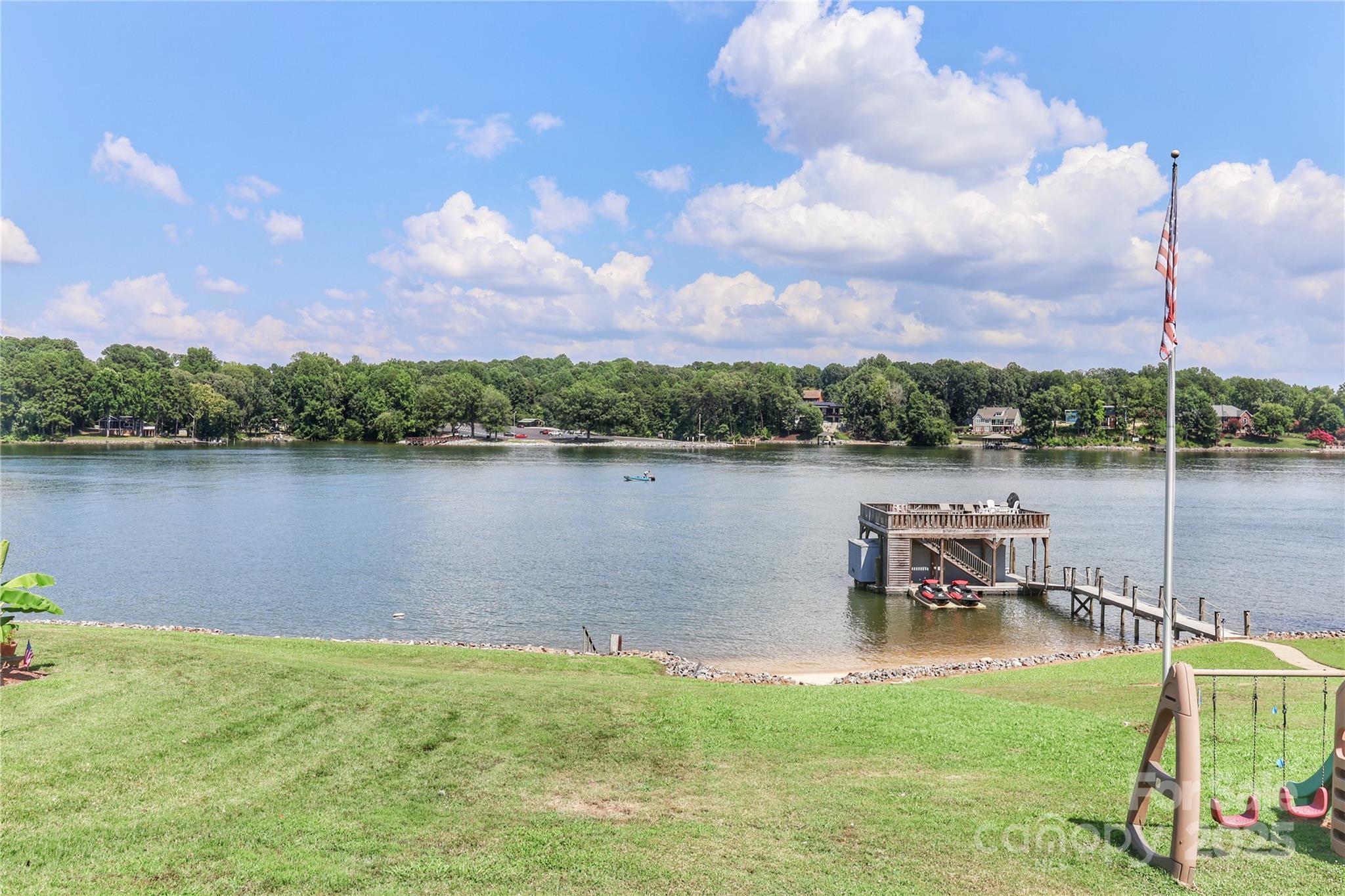 496 Kenway Loop Mooresville, NC 28117 - Photo 25 of 32 a view of a lake with a garden