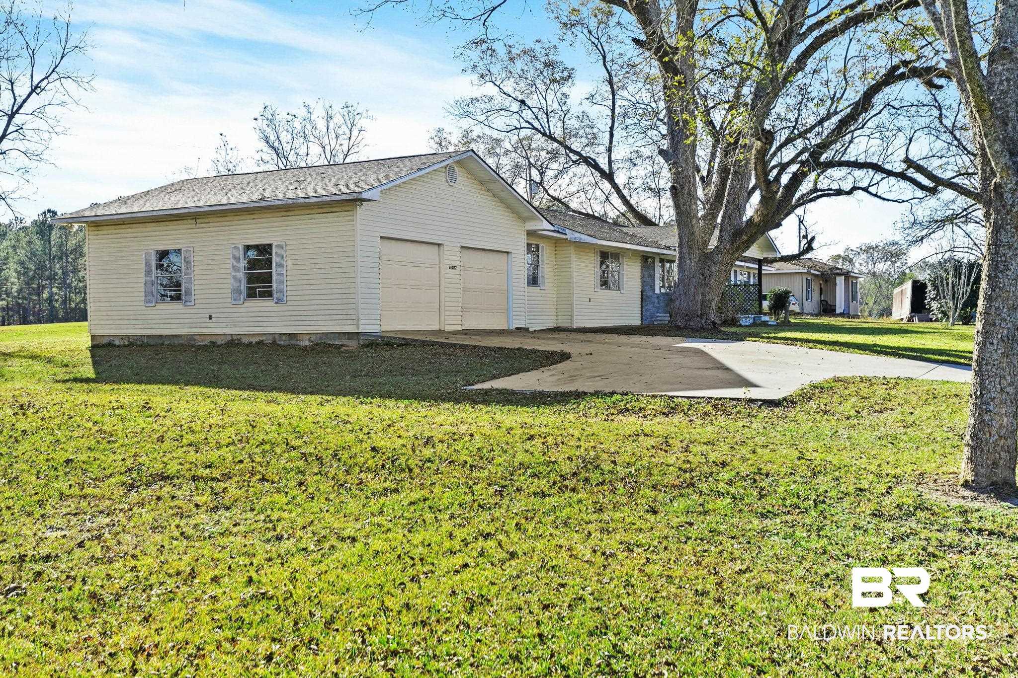 21267 Loop Road Andalusia, AL 36421 - Photo 7 of 72 Back of property featuring a lawn, driveway, and a patio area