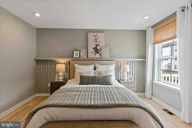 a bedroom with a large bed and a window