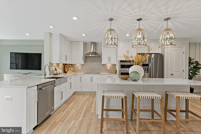 a kitchen with cabinets a sink and appliances in it