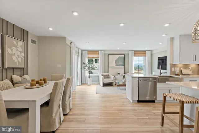 a living room with furniture and a kitchen