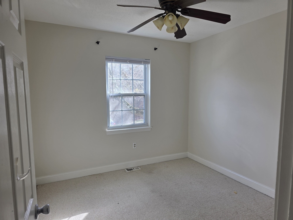 1201 Spring Valley Drive, Unit 1201 Andover, MA 01810 - Photo 12 of 18 an empty room with a window and a fan