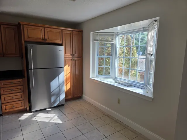 a refrigerator freezer sitting in a kitchen with stainless steel appliances granite countertop cabinets and a refrigerator