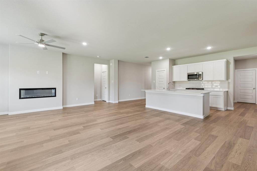 15213 Supreme Street Aledo, TX 76008 - Photo 31 of 32 a view of kitchen with granite countertop cabinets and refrigerator