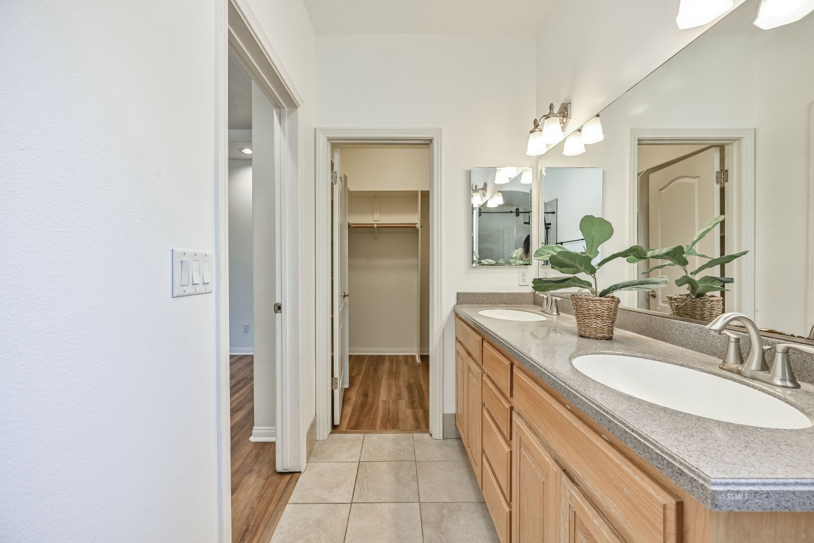 425 Acacia Street Ridgecrest, CA 93555 - Photo 38 of 49 a bathroom with a granite countertop sink a mirror and a shower