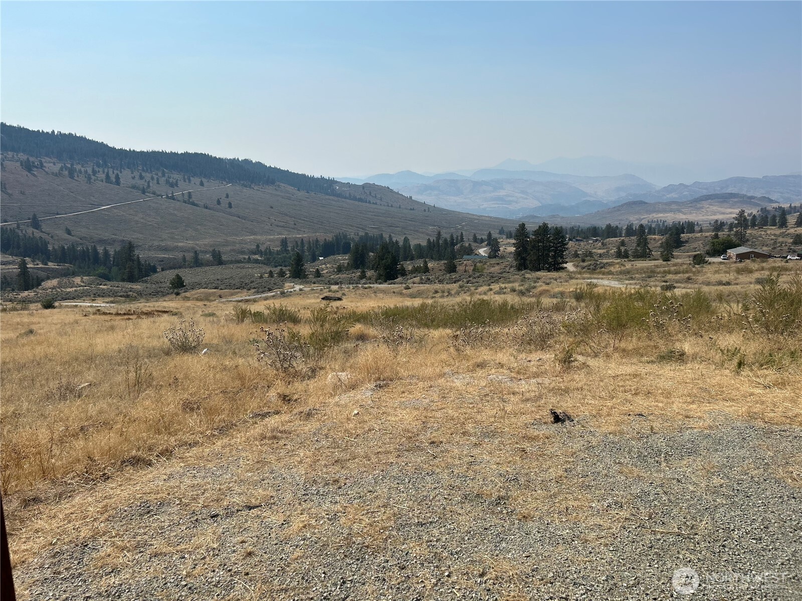 0 Old Tressle Road Oroville, WA 98844 - Photo 2 of 11 a view of a lake with mountains in the background