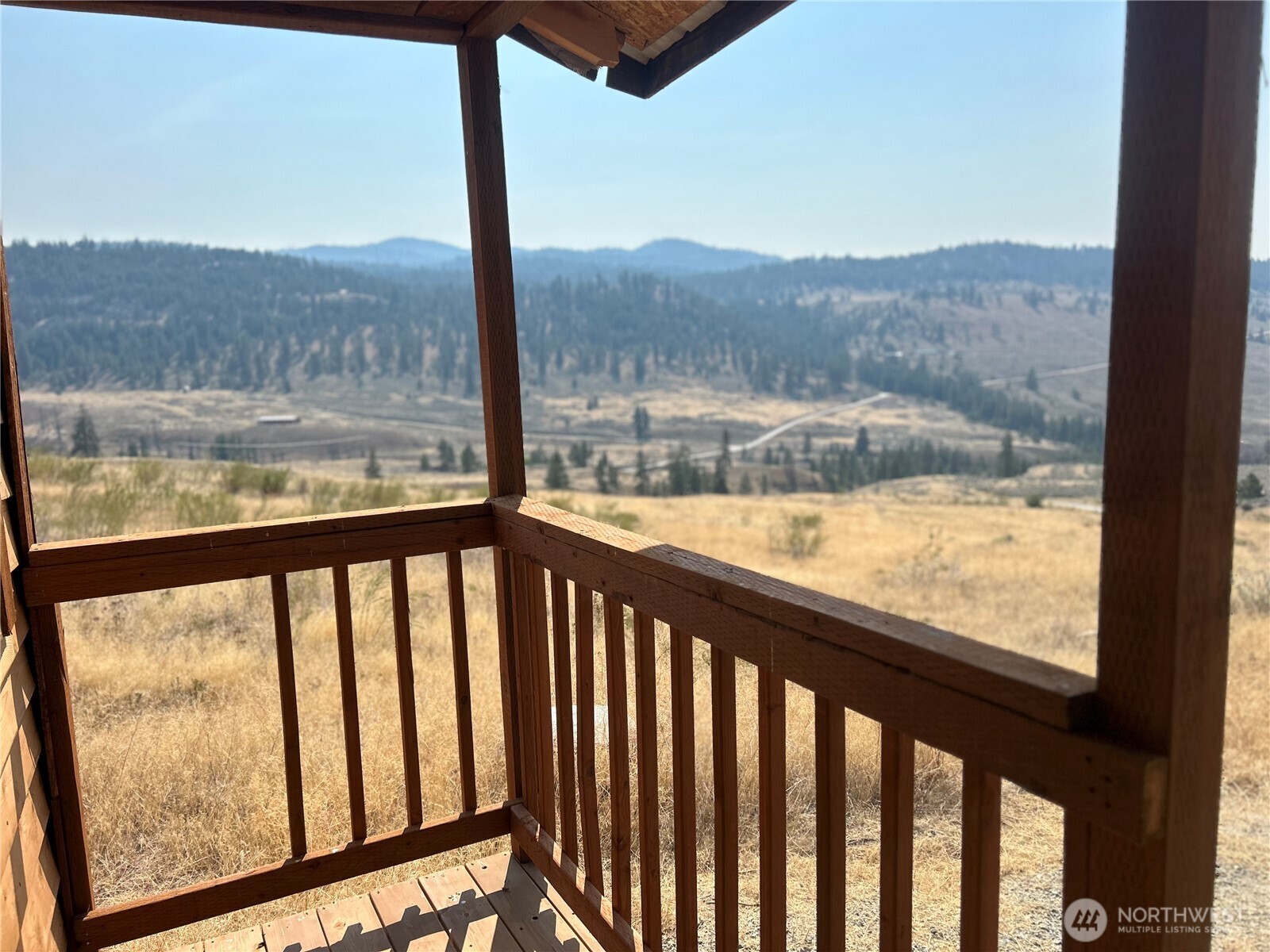 0 Old Tressle Road Oroville, WA 98844 - Photo 4 of 11 a view of balcony with wooden floor and mountain view