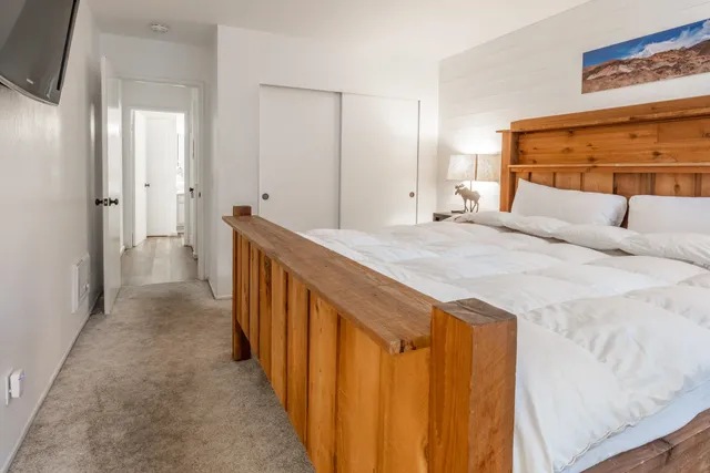 a bedroom with a bed and a flat screen tv