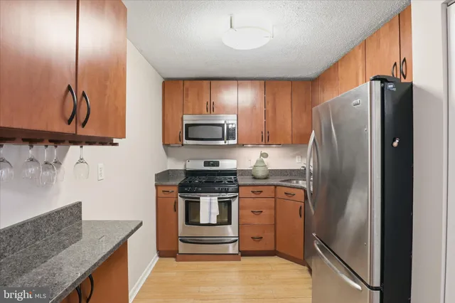 a kitchen with stainless steel appliances granite countertop a refrigerator stove and oven