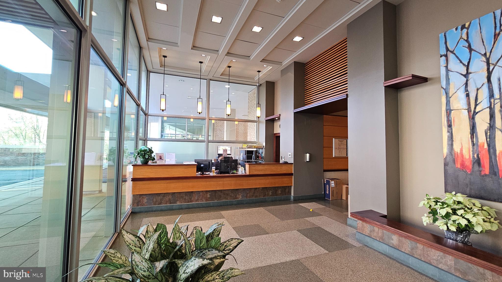 4600 South Four Mile Run Drive, Unit 207 Arlington, VA 22204 - Photo 20 of 53 a large room with lots of potted plants