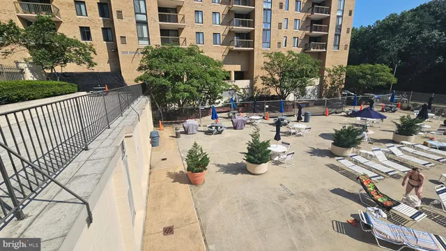 a view of a swimming pool with outdoor seating and plants