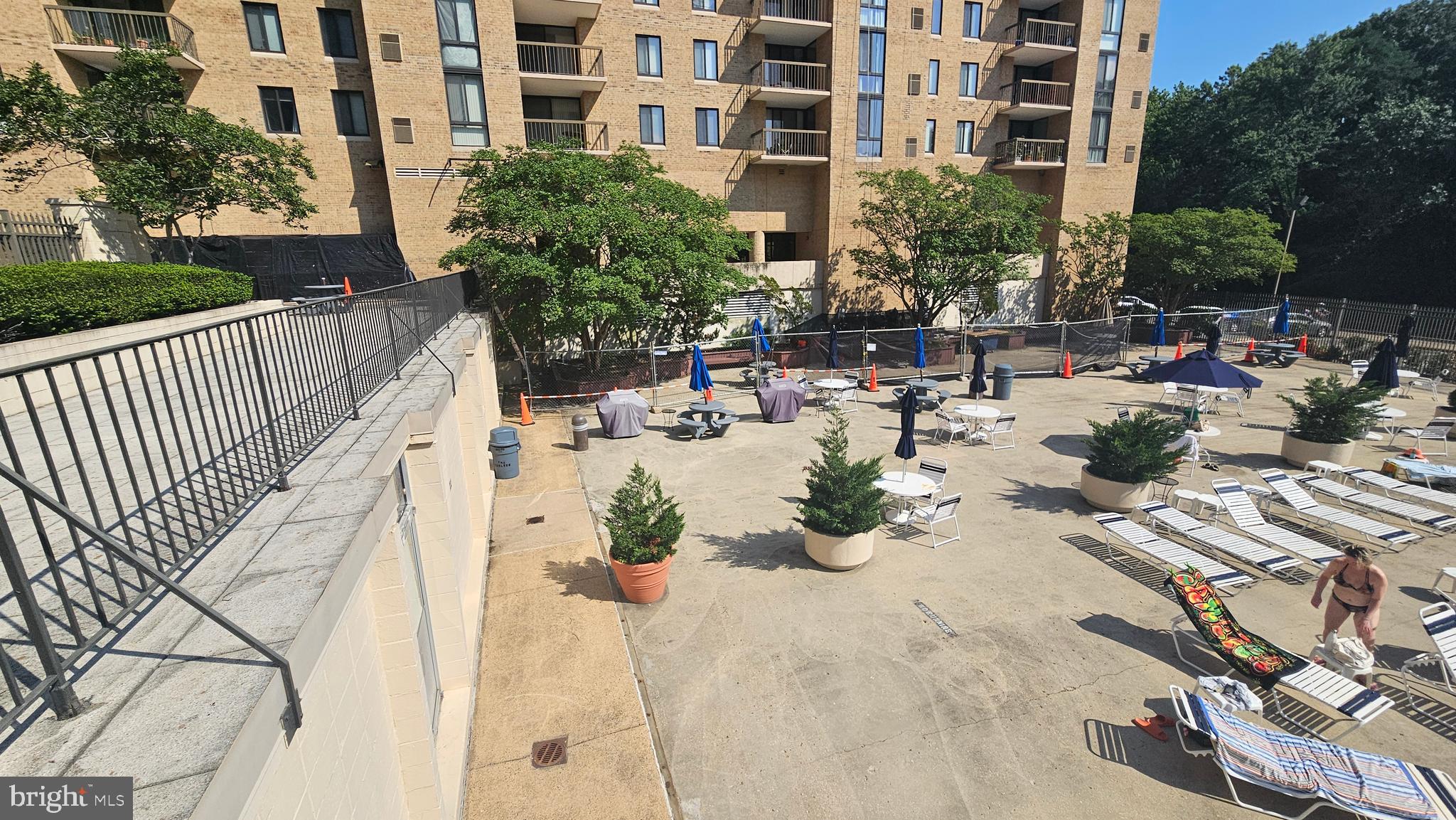 4600 South Four Mile Run Drive, Unit 207 Arlington, VA 22204 - Photo 26 of 53 a view of a swimming pool with outdoor seating and plants