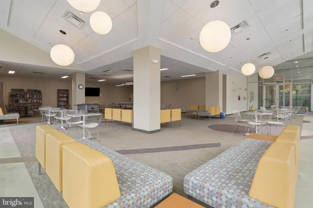 an open kitchen with lots of counter space and chandelier