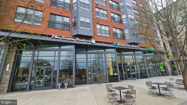 a view of a cafe with a table and chairs under an umbrella