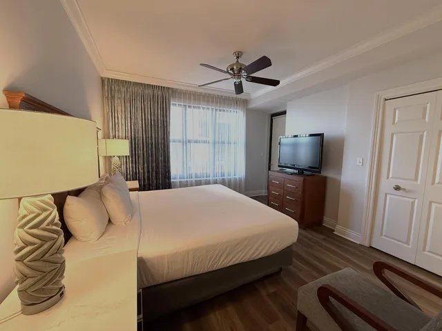 a bedroom with a bed and a flat screen tv