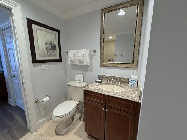 a bathroom with a toilet a sink and mirror