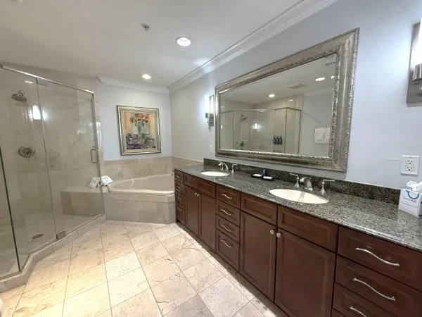 a bathroom with a granite countertop sink mirror toilet and bathtub
