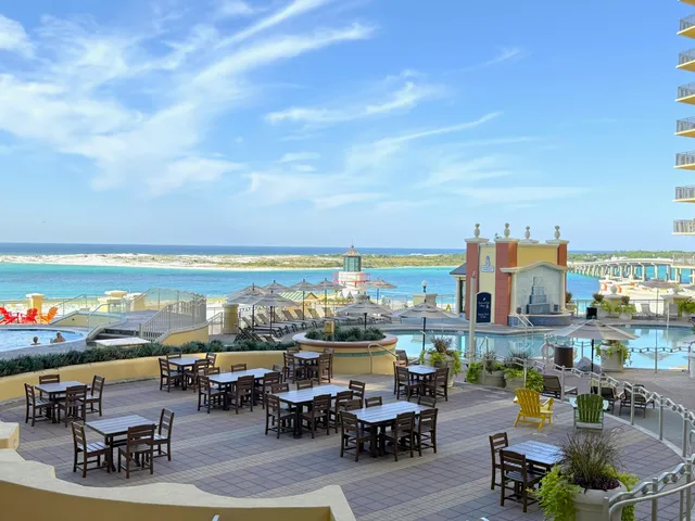 a roof deck with patio and ocean view