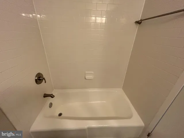 a bathroom with a tub and a shower