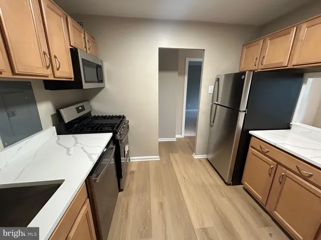 a kitchen with a sink a refrigerator freezer a washer and dryer