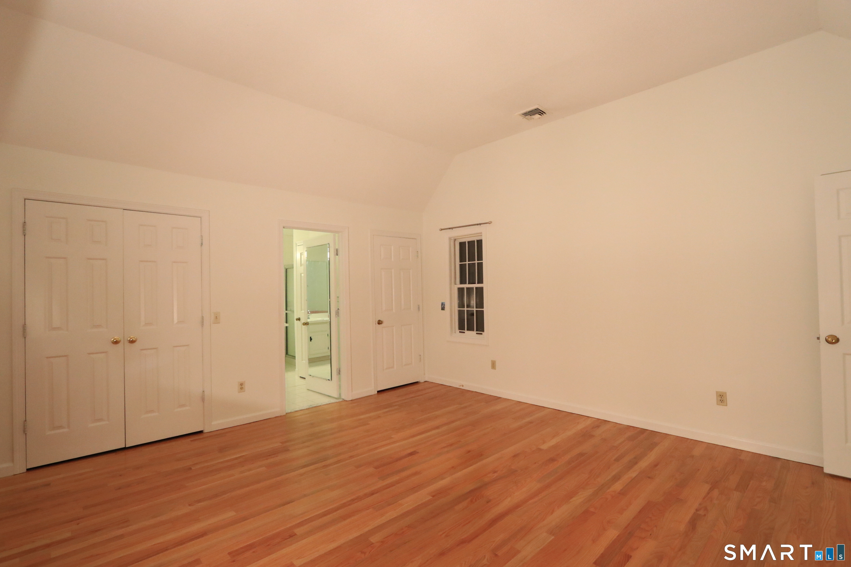 50 Wilton Crest Road, Unit 50 Wilton, CT 06897 - Photo 12 of 31 Primary bedroom with high ceiling and new hardwood floor