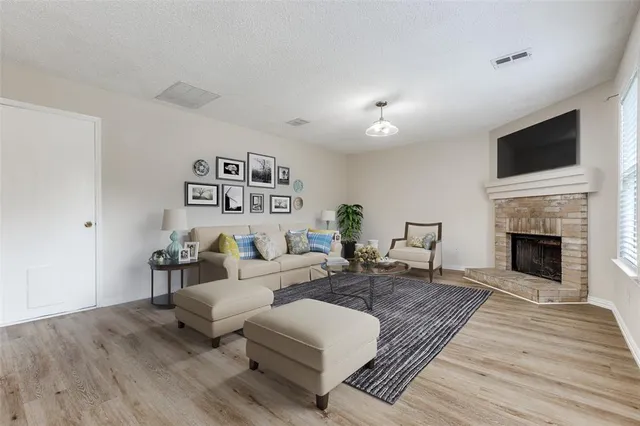 a living room with furniture fireplace and flat screen tv