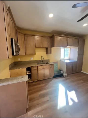 a kitchen with a sink cabinets and window