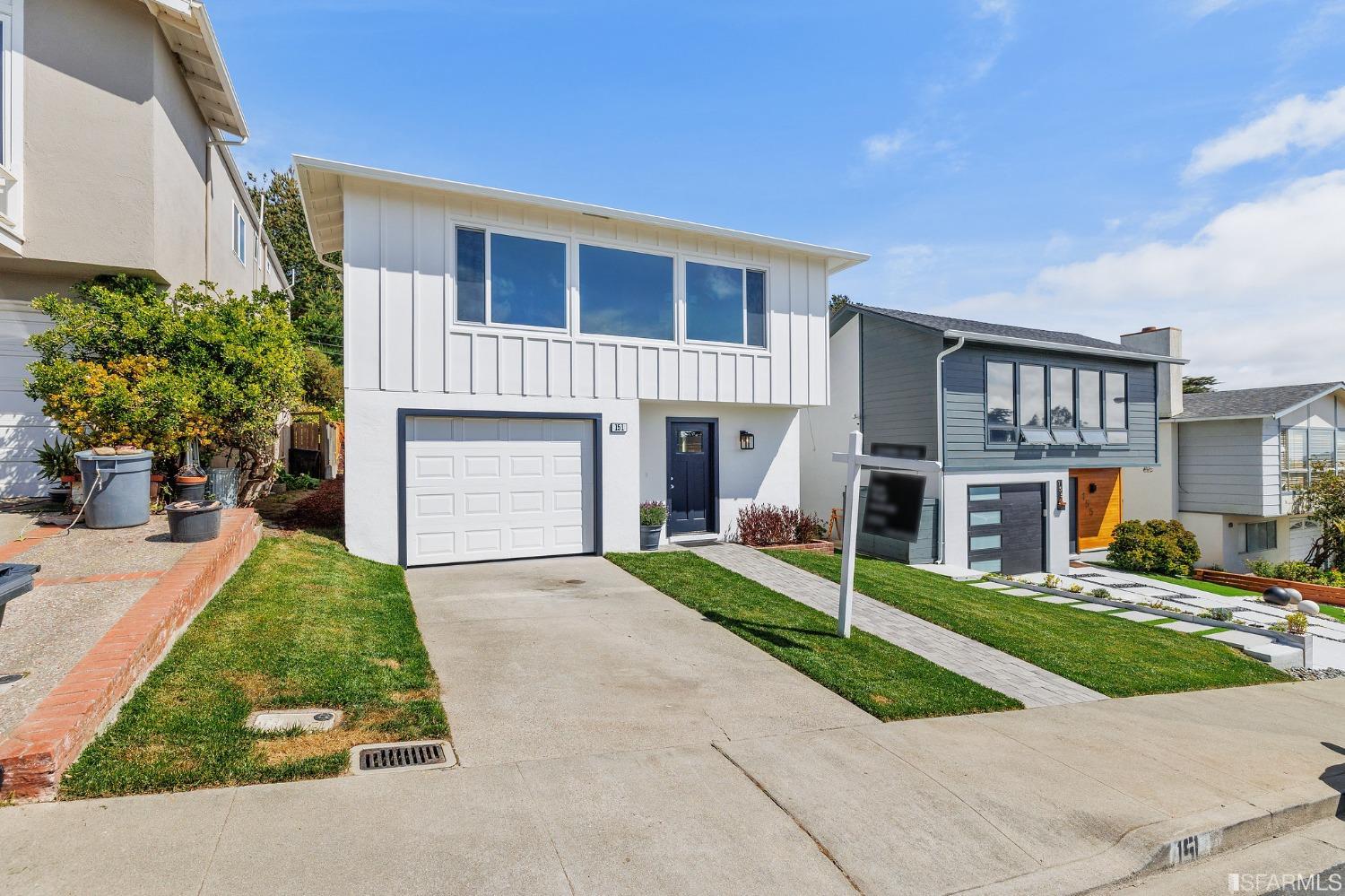 151 Longview Drive Daly City, CA 94015 - Photo 2 of 11 a front view of a house with a yard and garage