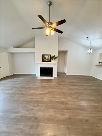 a view of a livingroom with a ceiling fan and window