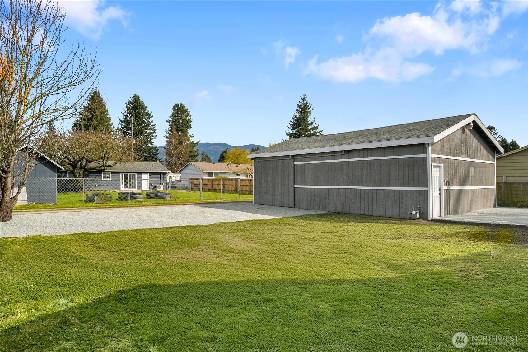 1006 Fidalgo Street Sedro-Woolley, WA 98284 - Photo 19 of 20 a view of a house with a swimming pool and a yard