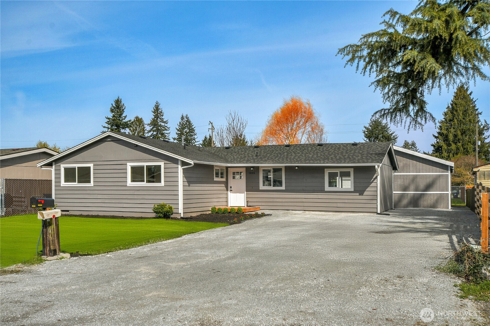 1006 Fidalgo Street Sedro-Woolley, WA 98284 - Photo 2 of 20 a front view of a house with a garden and yard
