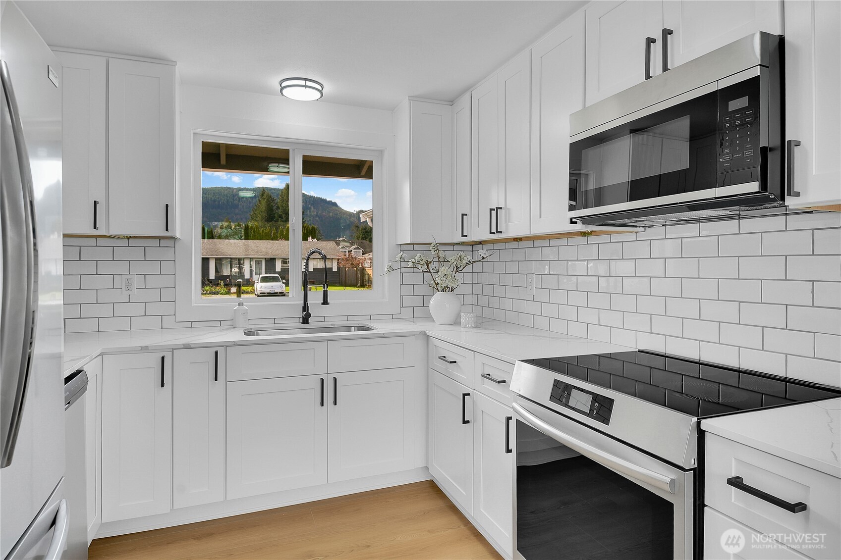 1006 Fidalgo Street Sedro-Woolley, WA 98284 - Photo 8 of 20 a kitchen with stainless steel appliances a sink stove and microwave