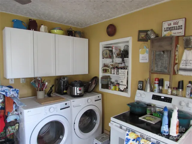 a kitchen with stainless steel appliances a counter top space cabinets and a window