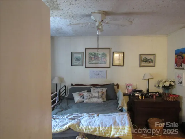 a bed room with a bed and a mirror