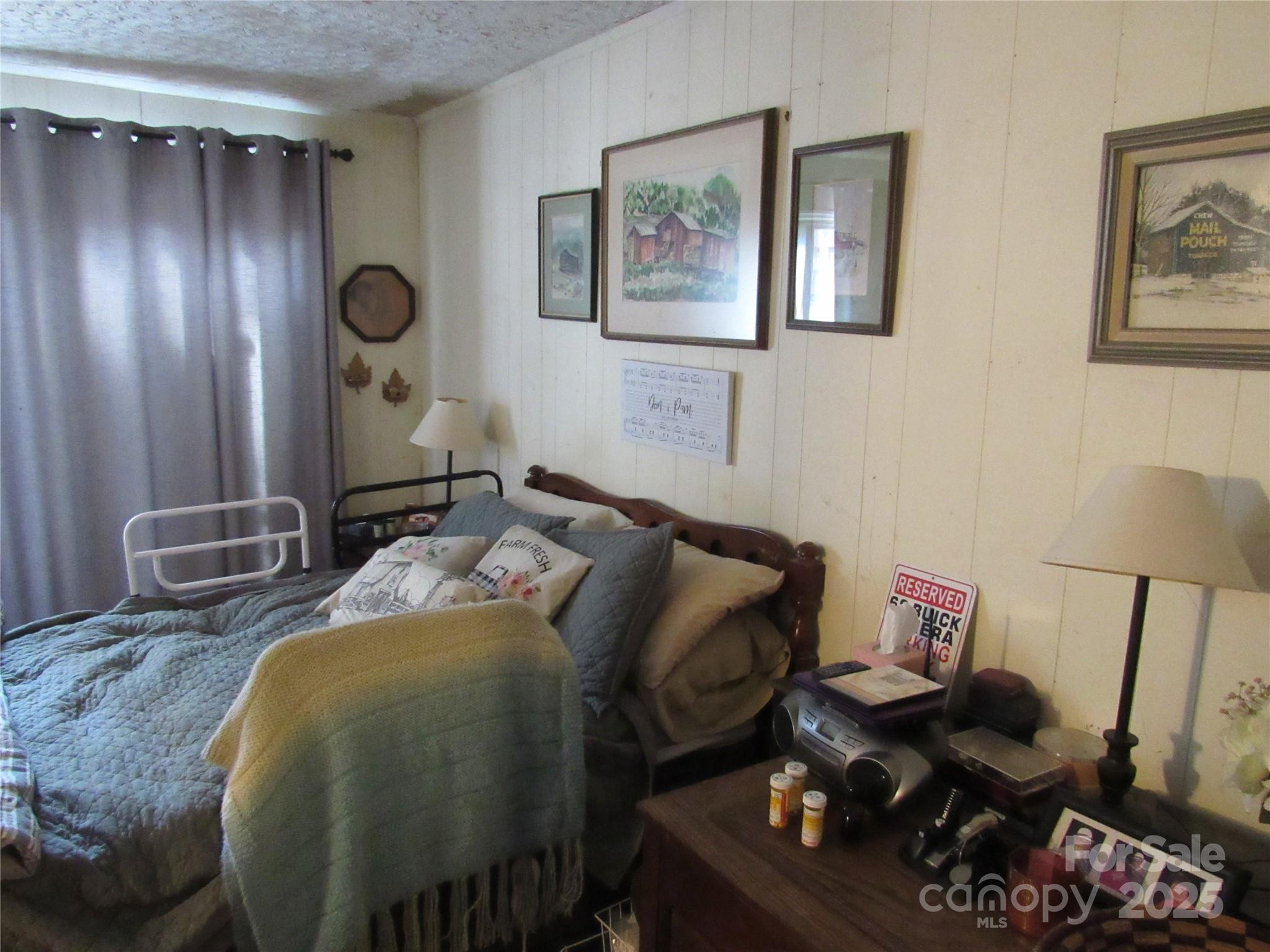 1144 Montreat Road Black Mountain, NC 28711 - Photo 19 of 30 a bed room with a bed and a mirror
