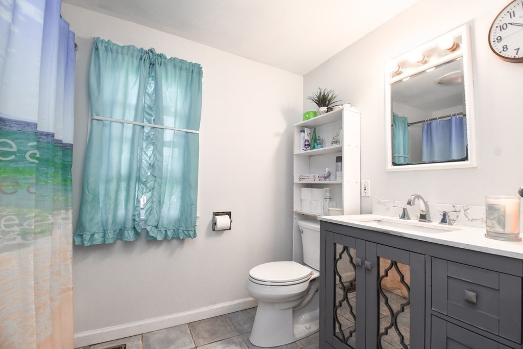 70 Intervale Road Springfield, MA 01118 - Photo 13 of 39 a bathroom with a toilet a sink and mirror